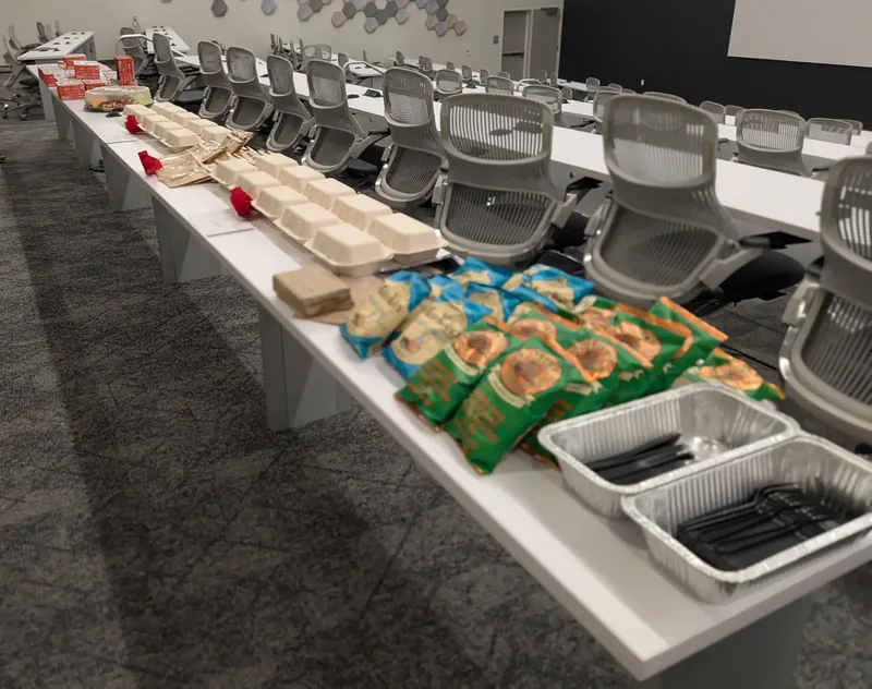 A corporate lunch arranged across a long conference table
